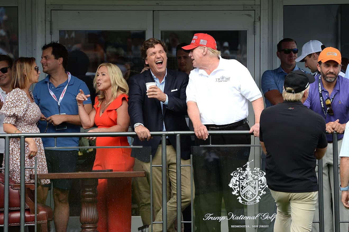Tucker Carlson with former President Trump at the 16th hole during the final LIV Golf Tournament held at the Trump National Golf Club in Bedminster, N.J., on July 31, 2022. Credit: L.E.MORMILE/Shutterstock.