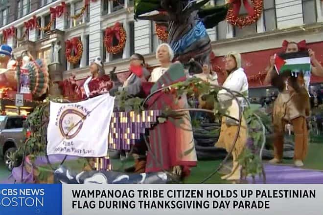 An individual member of the Mashpee Wampanoag tribe of American Indians displays a Palestinian flag at the Macy's Thanksgiving Day Parade in Manhattan on Nov. 23, 2023. Source: YouTube/“CBS” Boston.