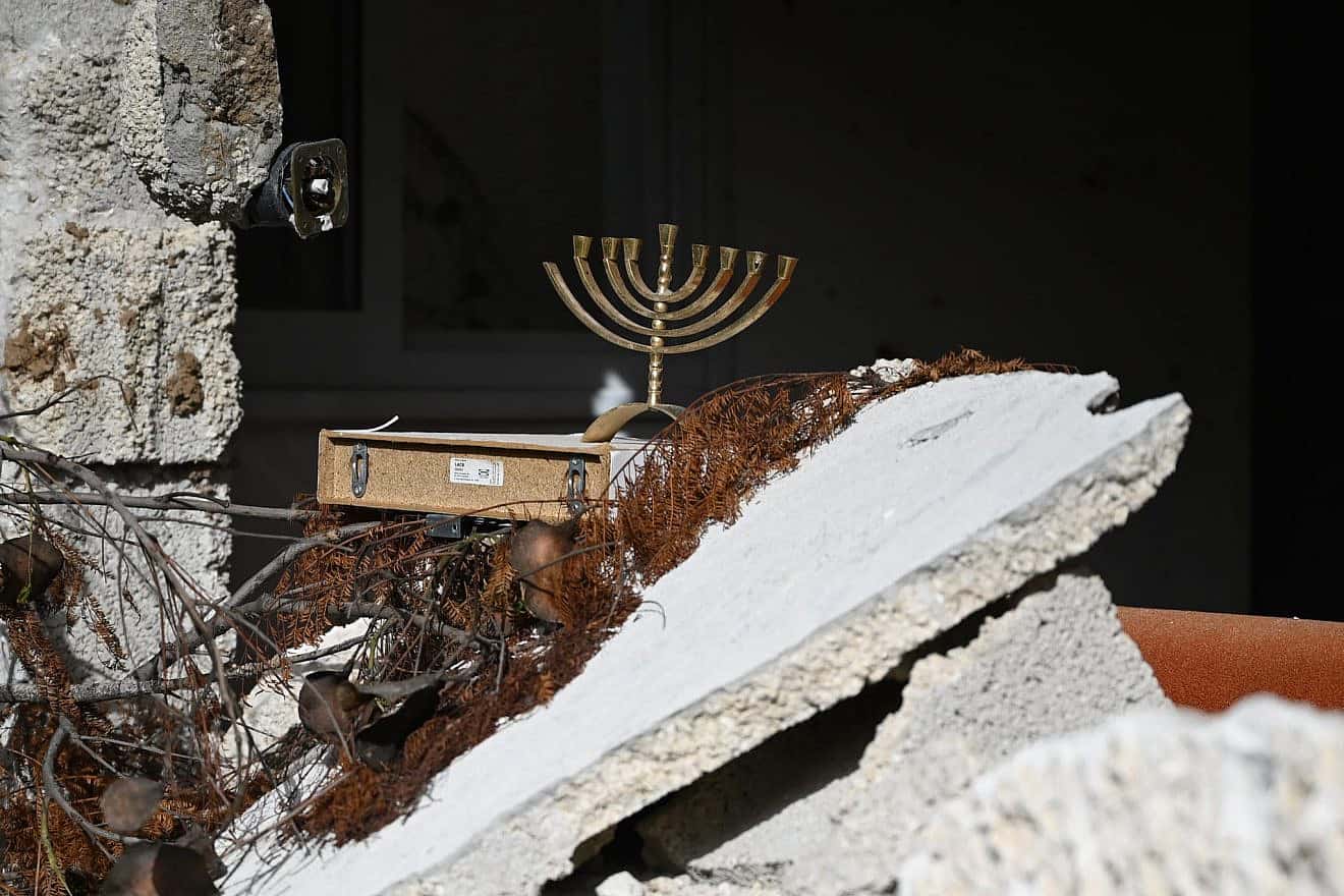 A menorah amid the destruction in Kibbutz Kfar Aza on Nov. 26, 2023. More than 100 residents of the kibbutz were massacred by Hamas on Oct. 7, 2023. Credit Yoav Dudkevitch/TPS.