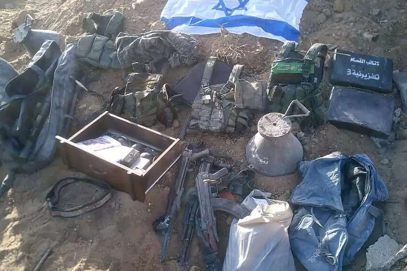 Materiel found by Israeli forces in the Gaza Strip, next to an Israeli flag. Credit: IDF Spokesperson's Unit.