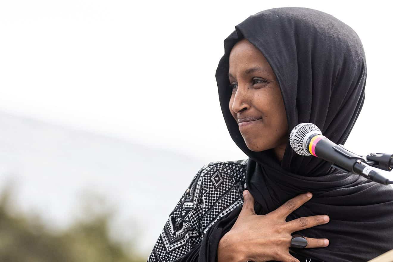 Rep. Ilhan Omar (D-Minn.) looks back at her daughter offstage as she addresses the crowd at the 2019 Youth Climate Strike in Washington, D.C. Credit: Paris Malone/Shutterstock.