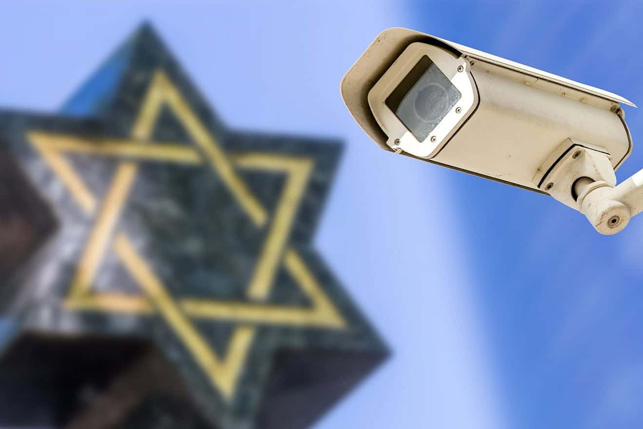 A security camera with a Star of David in the background. Photo: pixinoo/Shutterstock