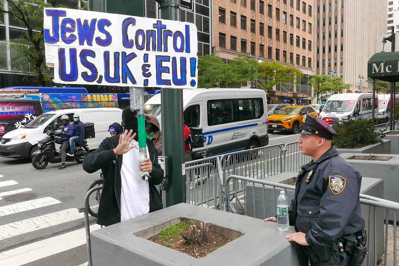 A masked man holds an anti-Jewish sign at a protest near the Israeli consulate in New York on Oct. 17, 2023. Photo by Joe Tabacca/Shutterstock.