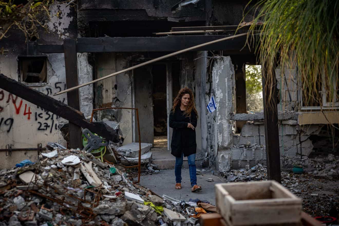 A woman amid the ruins of Kibbutz Be'eri after Hamas terrorists attacked, Dec. 20, 2023. Photo by Yonatan Sindel/Flash90.