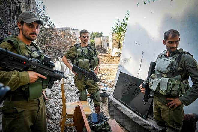 Israeli soldiers seen around the destruction caused by Hamas terrorists on Oct. 7, 2023 in Kibbutz Kfar Aza, Nov. 2, 2023. Photo by Arie Leib Abrams/Flash90.