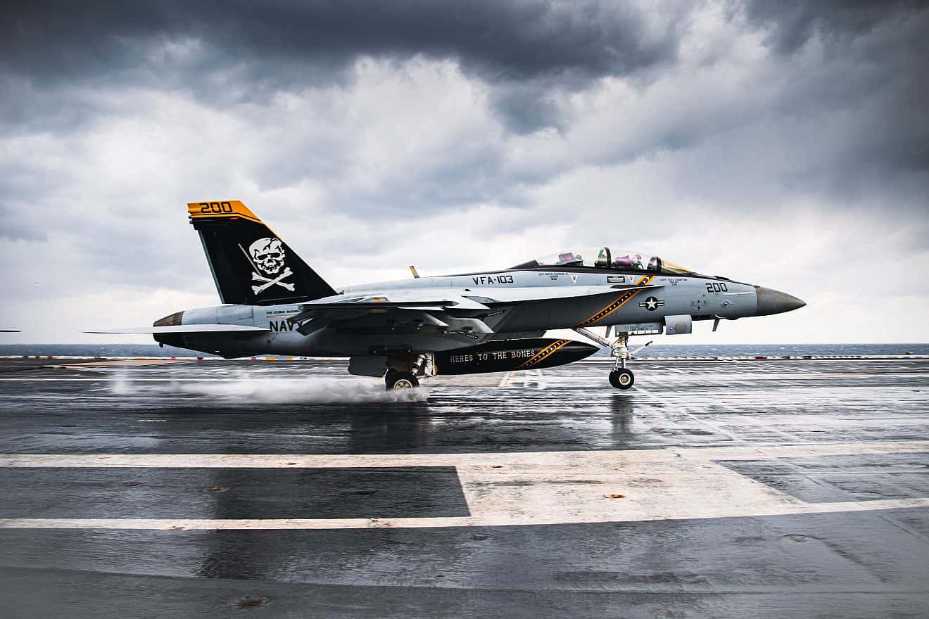 An F/A-18E/F Super Hornet from Strike Fighter Squadron (VFA) 103 performs a touch and go aboard the Nimitz-class aircraft carrier USS George Washington (CVN 73), Dec. 6, 2023. U.S. Navy photo by Mass Communication Specialist 3rd Class August Clawson.