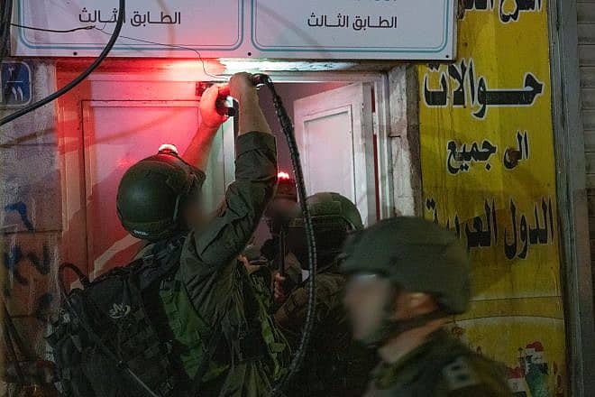 Israeli soldiers raid a foreign exchange office in Judea and Samaria, Dec. 27, 2023. Credit: IDF.