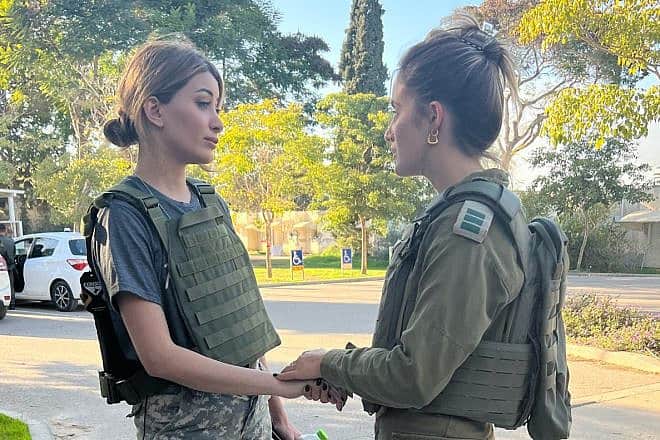 Sarah Idan (left) speaks with an IDF captain at the ruins of Kibbutz Kfar Aza, near the Gaza Strip, Dec. 28, 2023. Source: X.