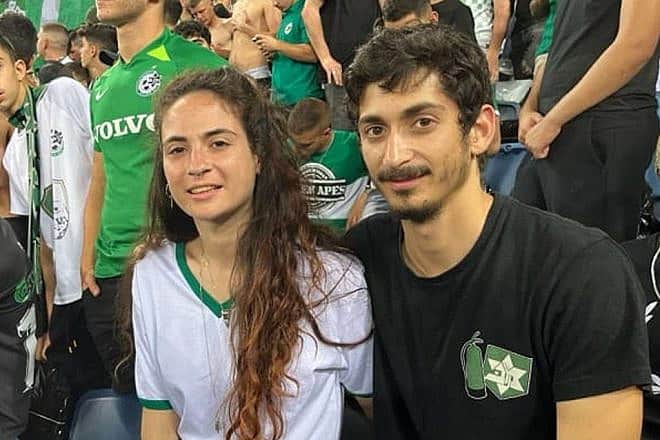Inbal Haiman (left) with her partner Noam Alon at a Maccabi Haifa soccer game. Photo: Courtesy.