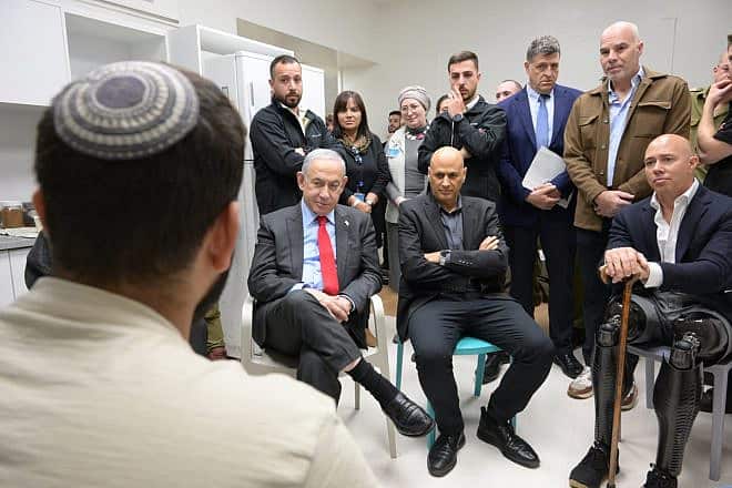 Israel Prime Minister Benjamin Netanyahu (seated, left) and Rep. Brian Mast (R-Fla., seated, right) meet with injured IDF soldiers and Border Police officers in the rehabilitation ward at Hadassah-Mt. Scopus hospital on Dec. 27, 2023. Credit: Amos Ben-Gershom (GPO).