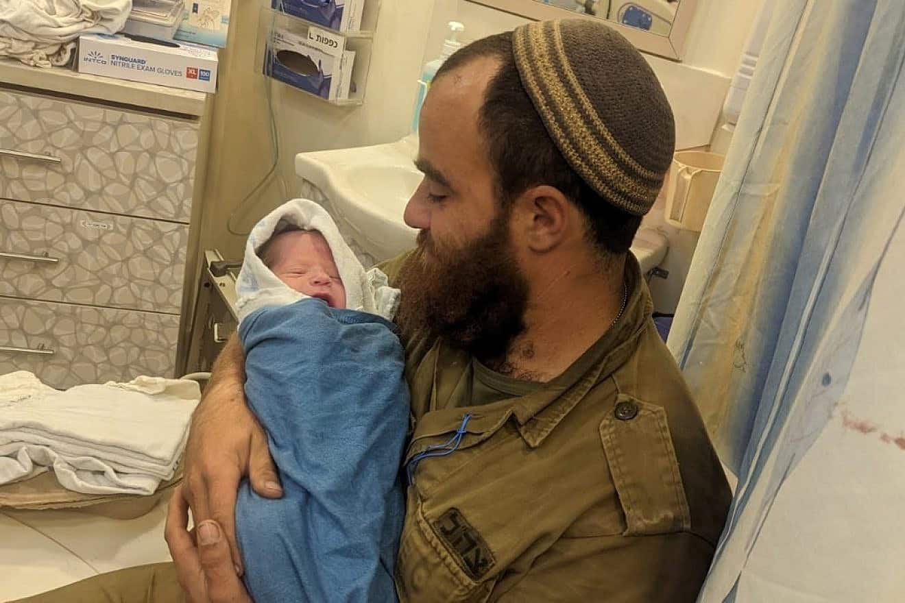 Yishai Cohen with his son, Eden Yosef. Credit: Courtesy of Neve Tzuf spokesperson.