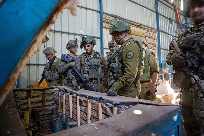 Israeli forces examining rocket parts in the largest weapons manufacturing site found since the start of the war against Hamas, in the Al-Bureij camp, central Gaza, Jan. 8, 2024. Credit: IDF.