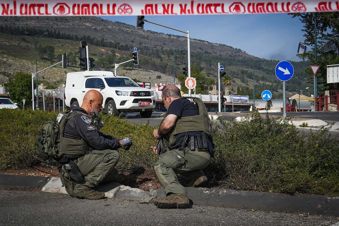 Israel Border Police officers look for fragments after a rocket from Lebanon hit Kiryat Shmona, Jan. 8, 2024. Photo by Ayal Margolin/Flash90.