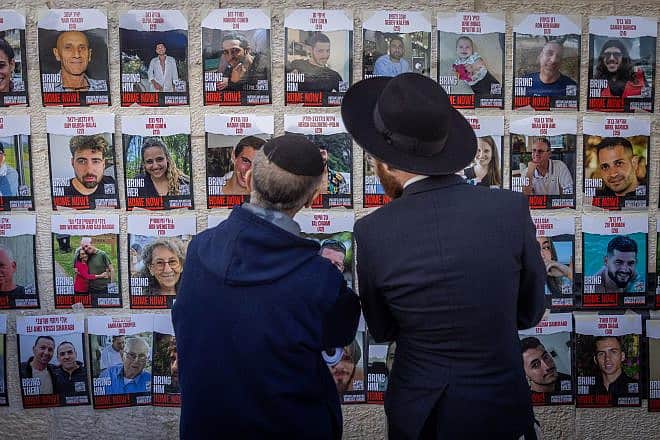 Jews gaze at photos of Israelis held captive by Hamas terrorists in Gaza, at the Western Wall Plaza in Jerusalem, Jan. 10, 2024. Photo by Chaim Goldberg/Flash90.