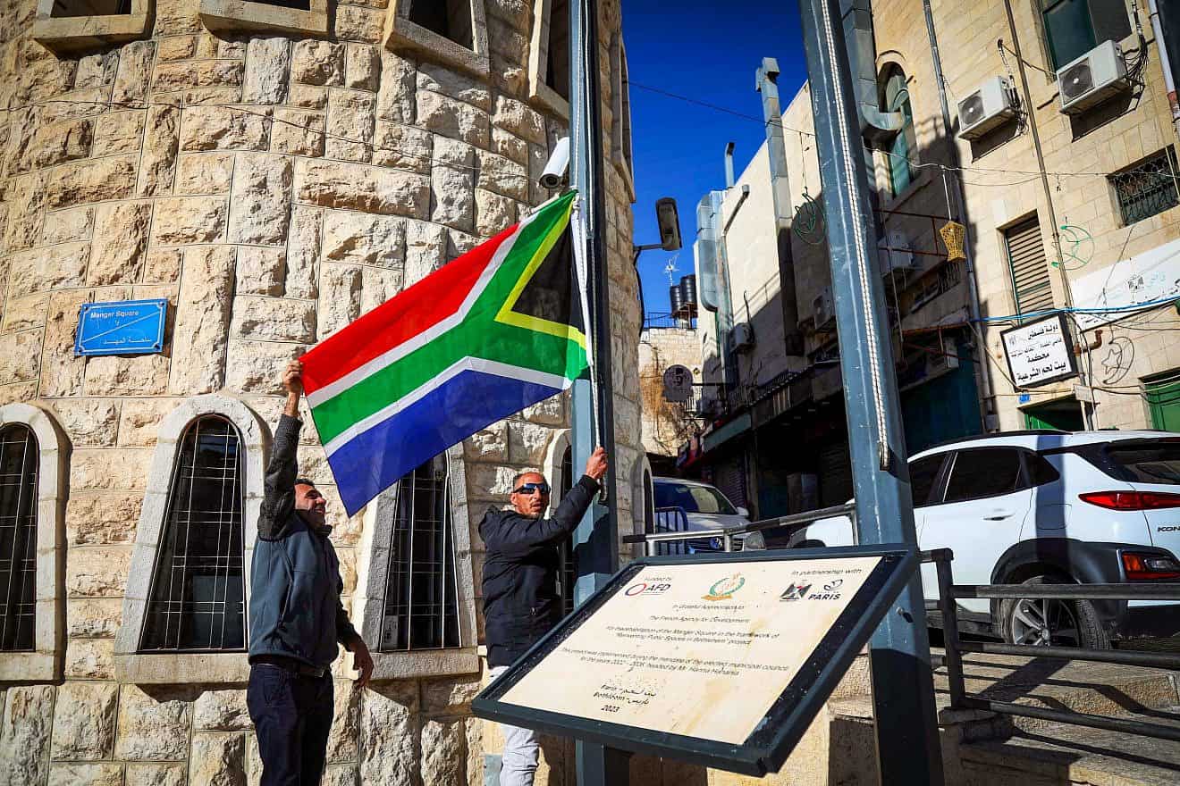 Bethlehem municipality employees raise a South African flag as a sign of support for the country's suit against Israel to the International Court of Justice, Bethlehem, Jan. 16, 2024. Credit: Wisam Hashlamoun/Flash90.