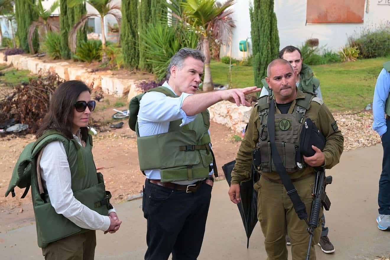 U.S. Senate candidate David McCormick (pointing) and wife Dina Powell McCormick visit Kfar Azza, one of the sites of Hamas's Oct. 7 massacre, in early January 2023. Credit: Courtesy.