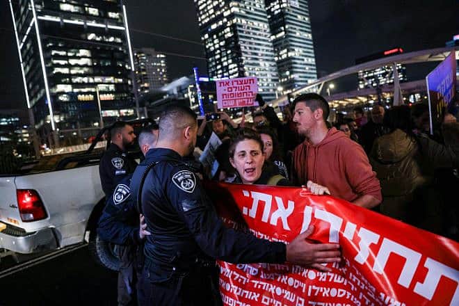 Protesters block the Ayalon Highway in Tel Aviv, calling for the release of Israelis held in Gaza, Jan. 24, 2024. Photo by Chaim Goldberg/Flash90.