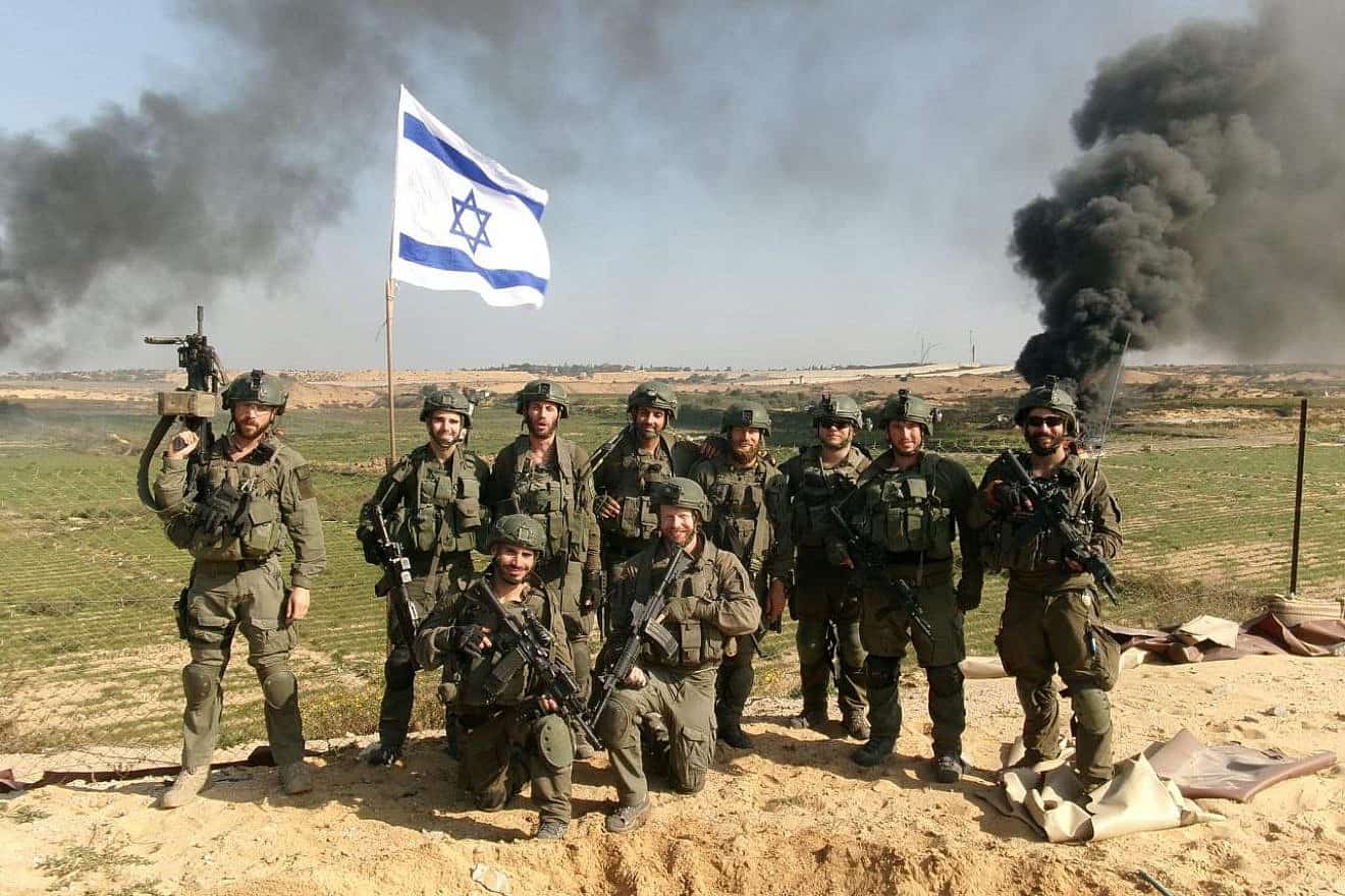 Members of the IDF Paratroopers Reconnaissance Battalion, including Haim Brenner (standing at left) and Netanel Sharvit (standing, fourth from left) in the Gaza Strip. Credit: Courtesy.