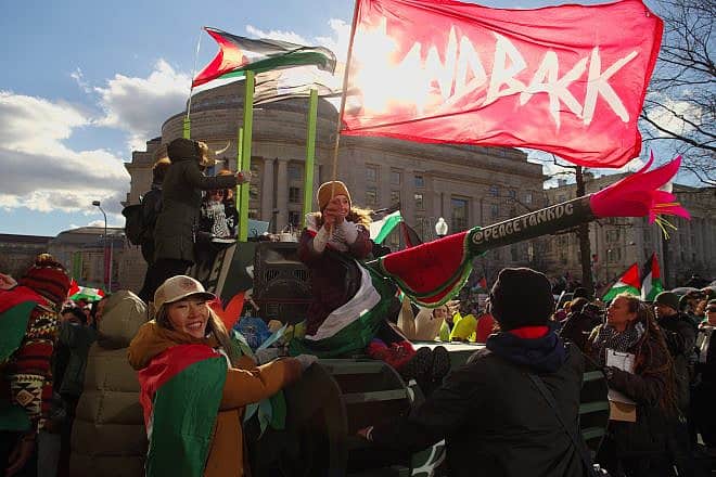 Pro-Hamas activists wheel a mock tank into Freedom Plaza during a “March for Gaza” on Jan. 13, 2024. Credit: Philip Yabut/Shutterstock.