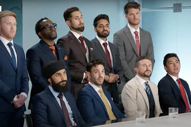 Asif Munaf (back, center), a physician and contestant on season 18 of the BBC reality show The Apprentice, is seen in a scene from the show's official trailer. Source: YouTube/BBC.