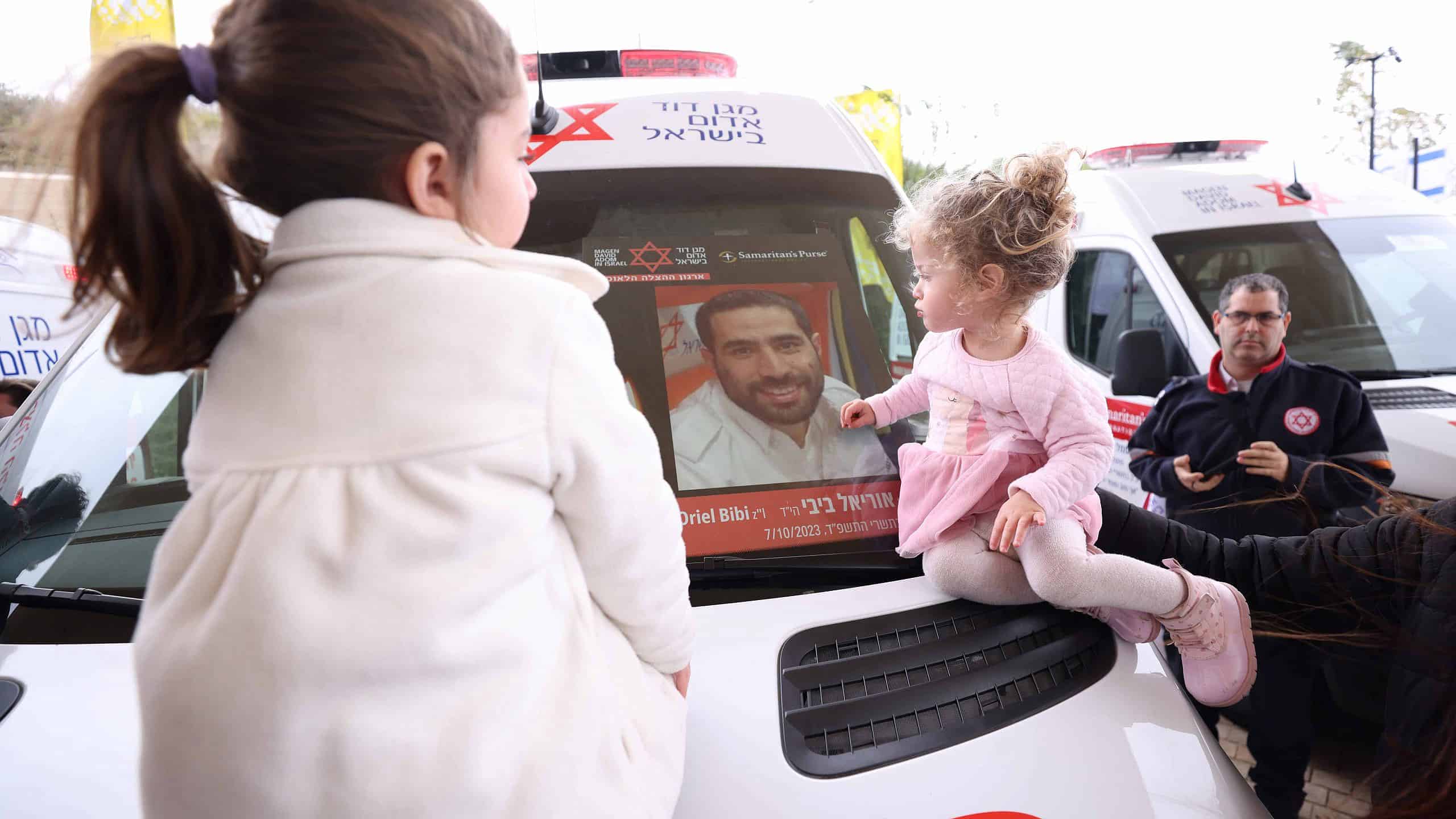 The children of MDA paramedic Oriel Bibi who fell in active service at the dedication of an ambulance in his memory donated by Samaritans Purse. Credit Eastside Studio scaled
