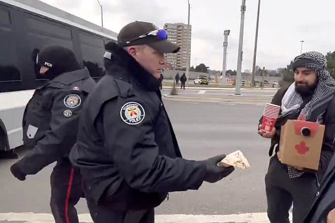 Toronto Police Service officers deliver coffee and food to anti-Israel protesters blocking a bridge in the city's most heavily-Jewish area on Jan. 6, 2023. Source: X/CarymaRules.