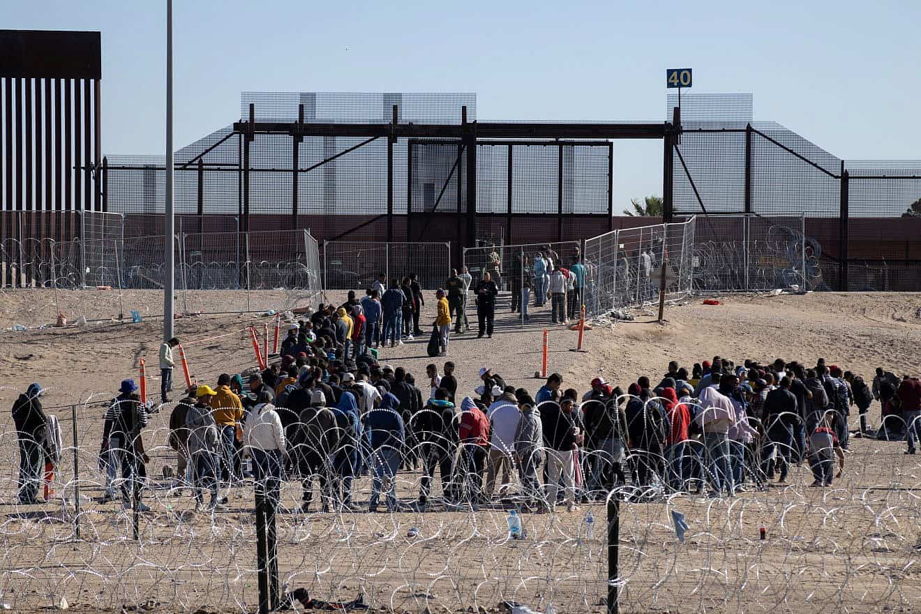Migrants, mainly from Venezuela, gather at the Mexico-U.S. border, seeking asylum before Title 42 ends, May 13, 2023. Credit: David Peinado Romero/Shutterstock.