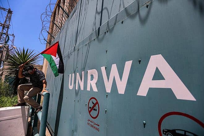 A Palestinian man outside the United Nations Relief and Works Agency for Palestine Refugees in the Near East (UNRWA) in Gaza City protests cuts to aid on June 20, 2023. Credit: Anas-Mohammed/Shutterstock.
