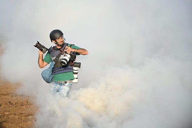 A press photographer covers an IDF exercise in northern Israel, Jan. 4, 2024. Photo by Yoav Dudkevitch/TPS.