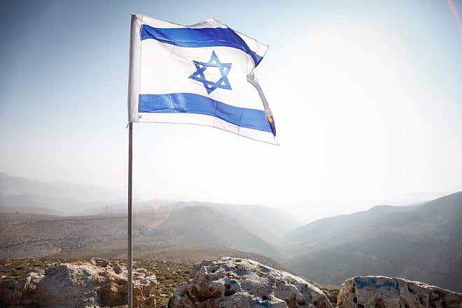 An Israeli flag in the Jordan Valley, near the community of Ma'ale Efraim, Jan. 2, 2014. Photo by Uri Lenz/Flash90.