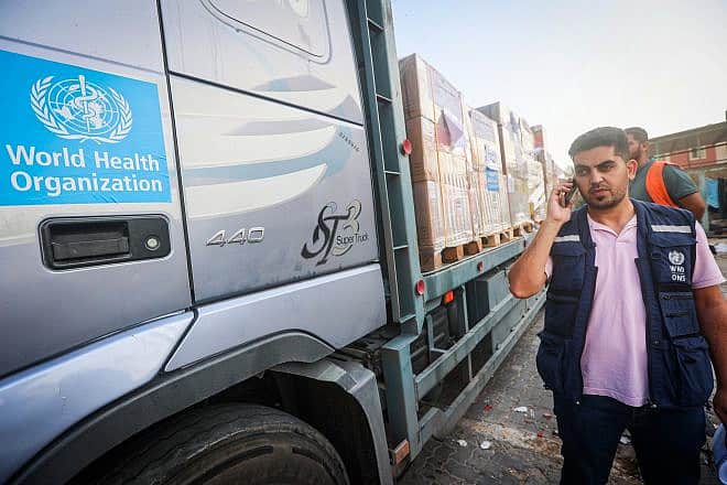 Palestinians unload medical aid from a truck at the Nasser hospital in Khan Yunis, in the southern Gaza Strip, on Oct. 23, 2023.  Photo by Atia Mohammed/Flash90.