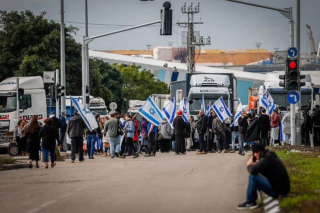 People block the entrance to Ashdod Port during a protest against aid entering the Gaza Strip, Feb. 1, 2024. Photo by Chaim Goldberg/Flash90.