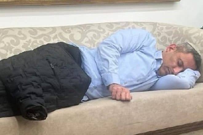 Sderot Mayor Alon Davidi sleeps on a couch at the Prime Minister's Office in Jerusalem, Feb. 5, 2024. Source: X.