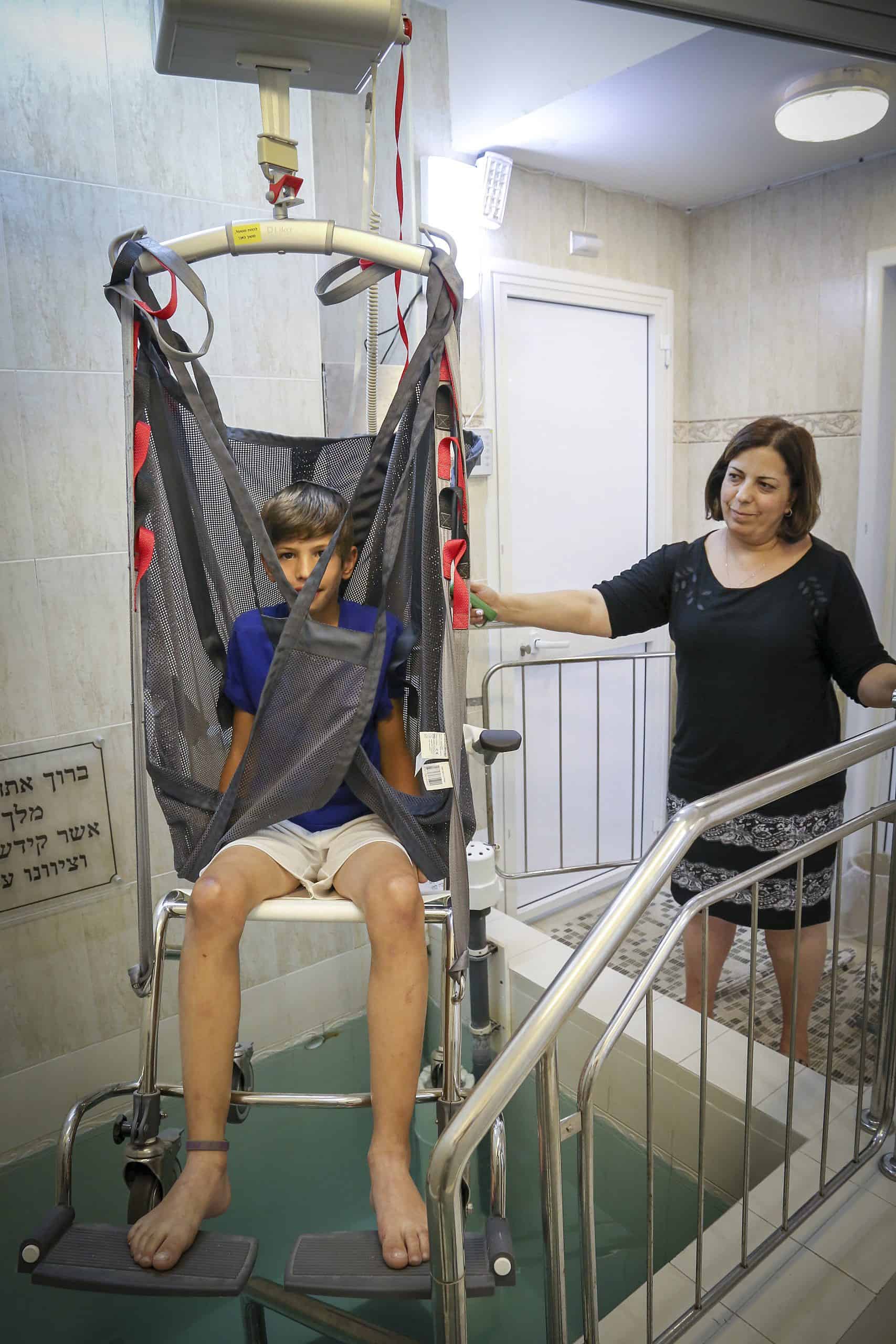 Jewish Boy in Wheelchair at Mikvah