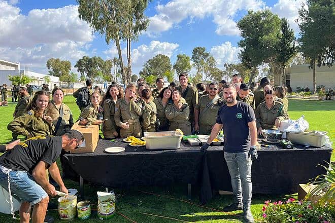 Shimon Biton feeds IDF soldiers at an army base. Photo: Courtesy,
