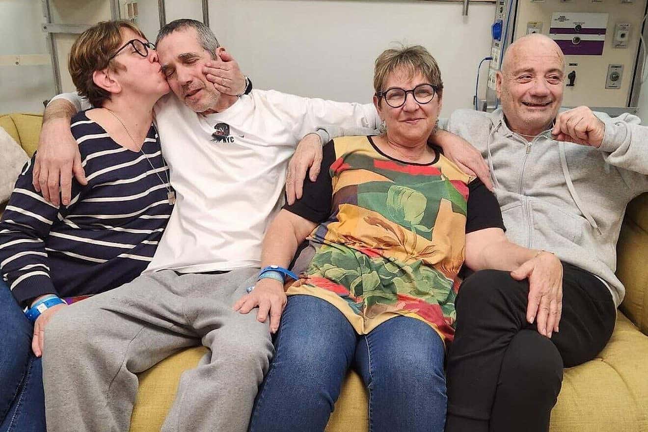 Freed Israeli hostages Fernando Simon Marman (left) and Louis Har at Sheba Medical Center in Ramat Gan, Israel. Also pictured kissing Marman is his sister, Gabriela Leimberg, and his other sister and Har's partner, Clara Marman, on Feb. 12, 2024. Source: X.
