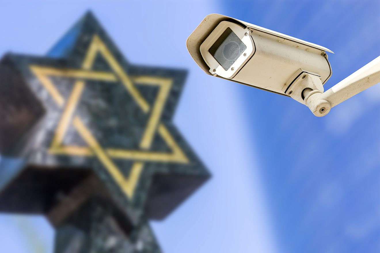 A security camera with a Star of David in the background. Credit: pixinoo/Shutterstock.