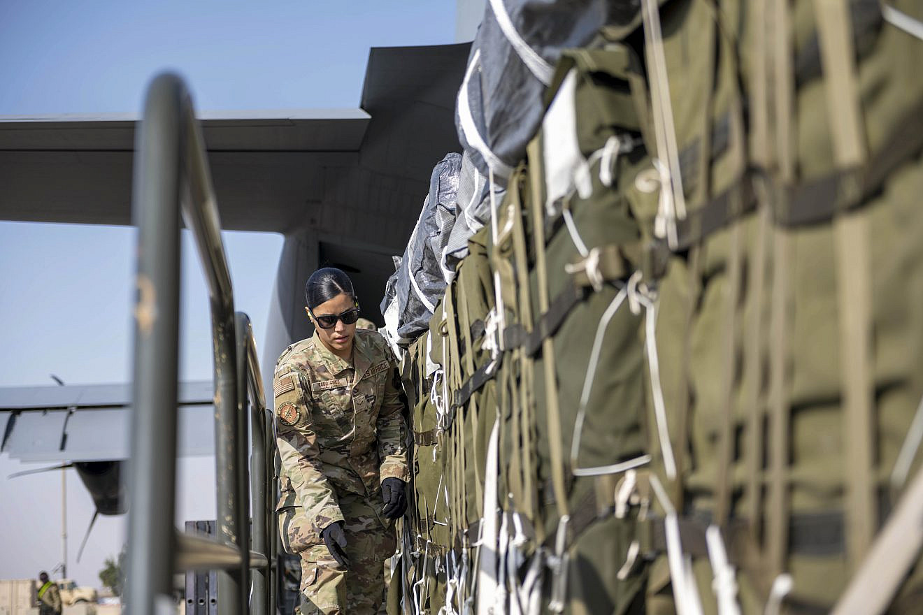 A U.S. Air Force airman prepares bundles of humanitarian aid, including more than 38,000 halal meals, destined for an airdrop over Gaza on March 7, 2024.  Credit: U.S. Air Force photo.