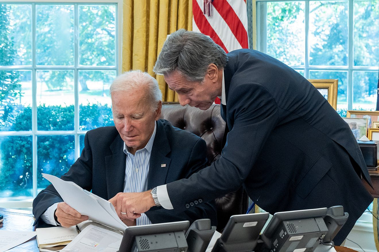 U.S. President Joe Biden, joined by Secretary of State Antony Blinken, is briefed on the terrorist assault on Israel on Oct. 7, 2023, in the Oval Office of the White House.  Credit: Cameron Smith/White House.
