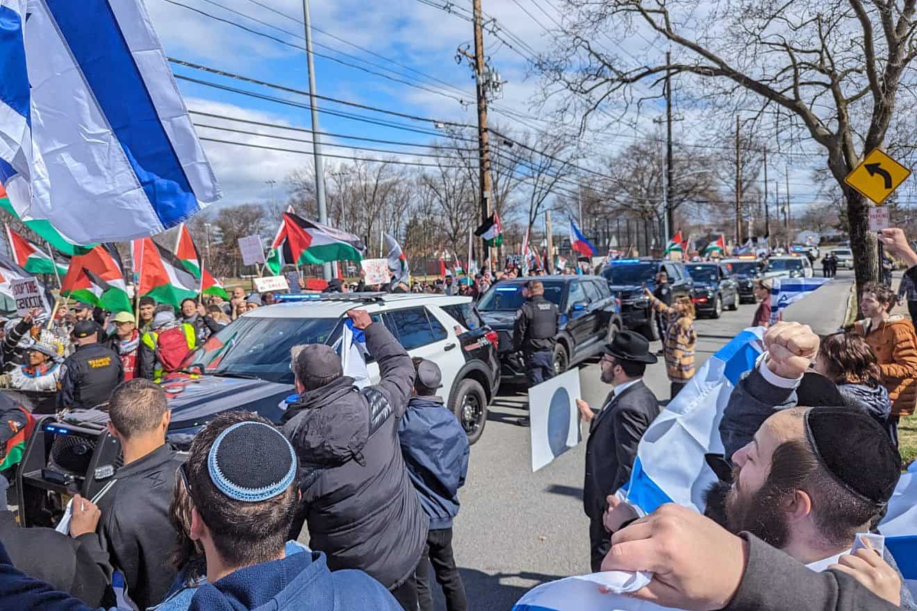Hundreds of anti-Israel protesters carried Palestinian flags and yelled pro-Hamas slogans outside Congregation Keter Torah in Teaneck, N.J., in response to an event promoting the purchase of real estate in Israel, March 10, 2024. Credit: The Jewish Link.