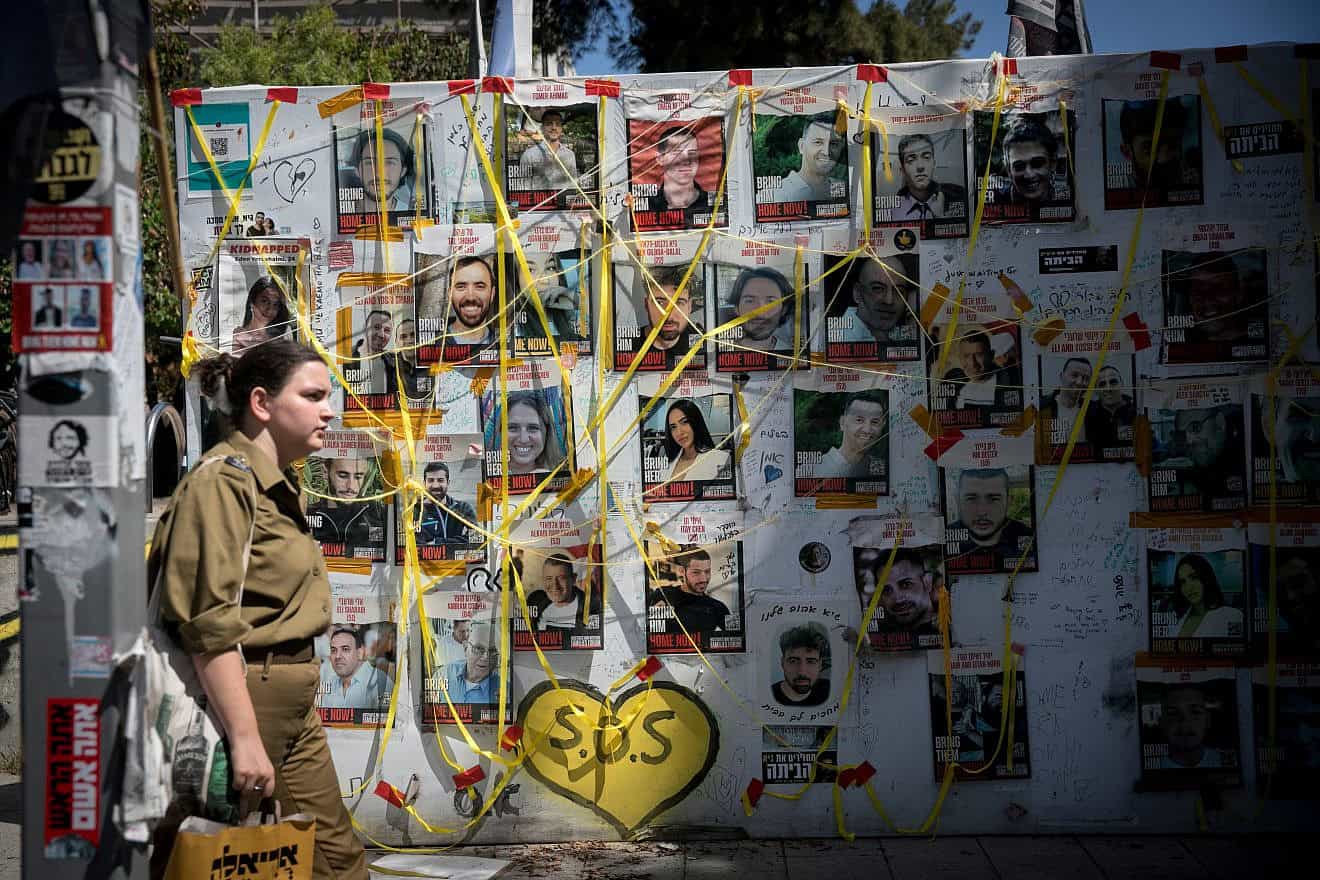 Pedestrians walk past pictures of Israelis held hostage by Hamas terrorists in Gaza at "Hostage Square" in Tel Aviv, June 16, 2024. Photo by Miriam Alster/Flash90.