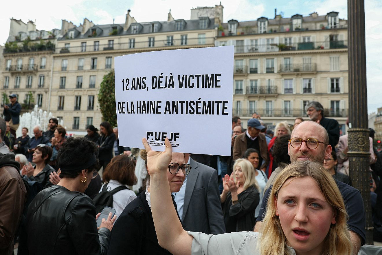 "Twelve years old and already a victim of antisemitic hate," the placard reads at the protest in the Place de l'Hôtel de Ville ("City Hall Square") in Paris, June 19, 2024. Photo by Alain Jocard/AFP via Getty Images.