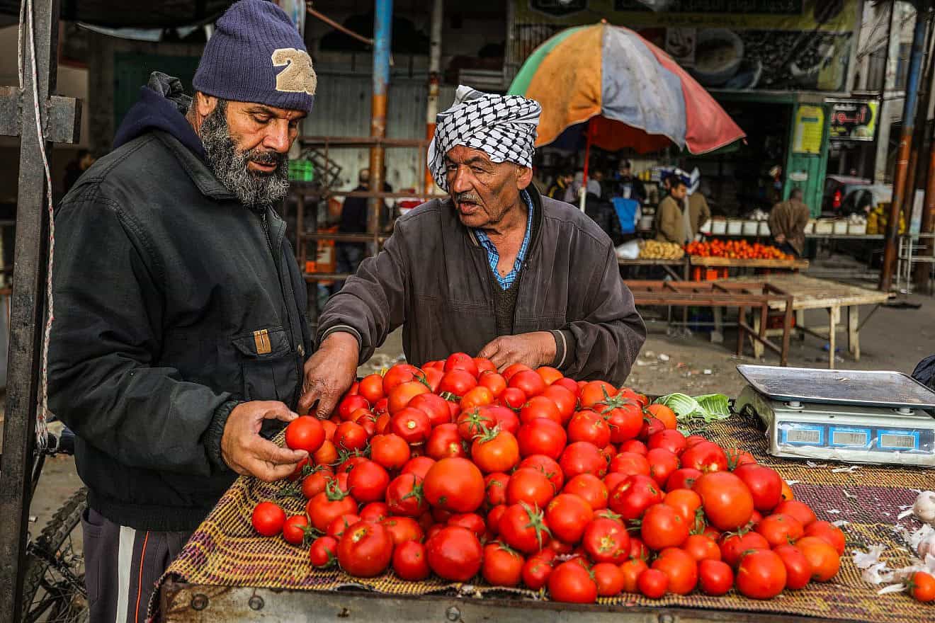 Palestinians shop for fruit and vegetables at a market in Rafah, in the southern Gaza Strip, on Jan. 13, 2024. Photo by Abed Rahim Khatib/Flash90.