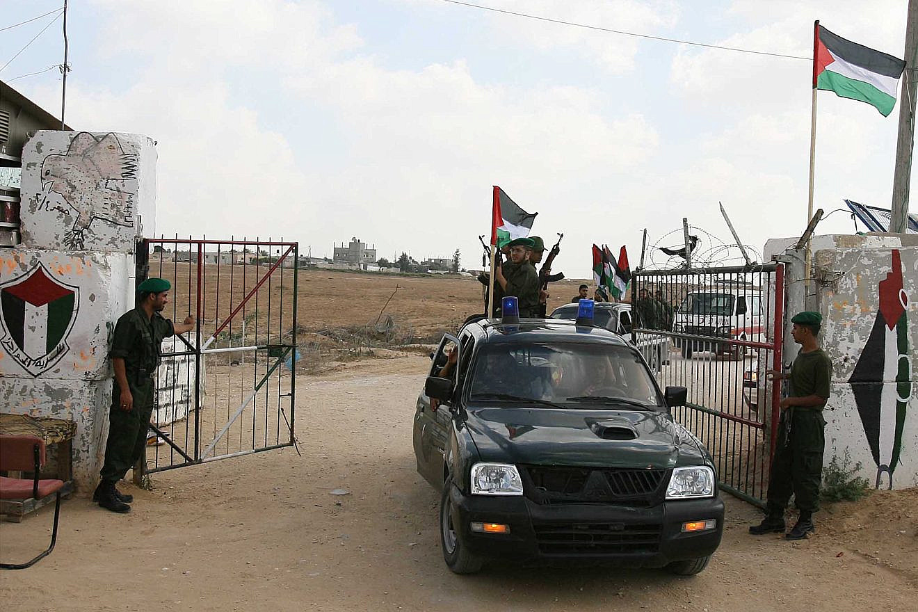 A Hamas security officer opens a gate to the Philadelphi Corridor between Egypt and Gaza near Rafah, July, 1, 2007. Photo by Ahmad Khateib/Flash90.